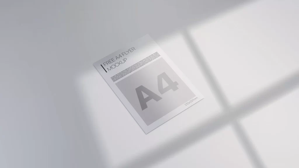 Minimalist free A4 flyer mockup lying flat on a light grey surface with natural window shadow overlays in 8K resolution.